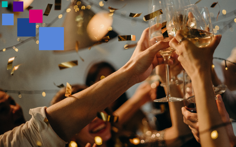Several people toast with champagne glasses at a fundraising event.